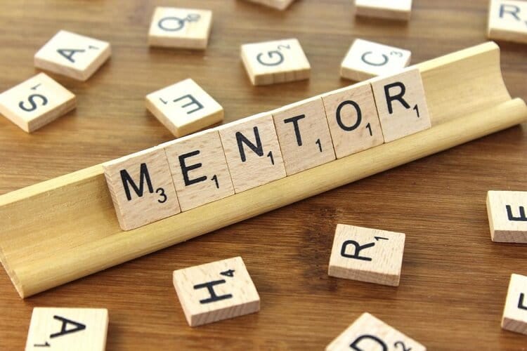 the word mentor written with scrabble letters