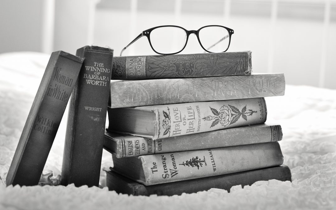 the best motivational books and an reading glass on top